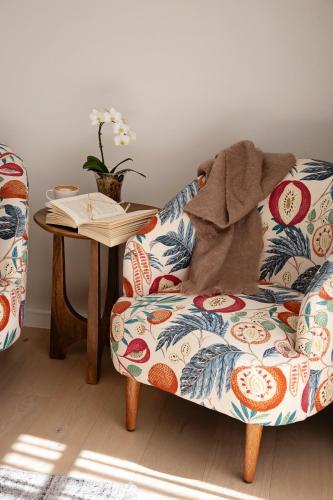 a living room with a couch and a table at La Petite Ferme in Franschhoek