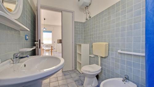 a bathroom with a sink and a toilet at Residence La Corte by Salento Affitti in Marina di Mancaversa