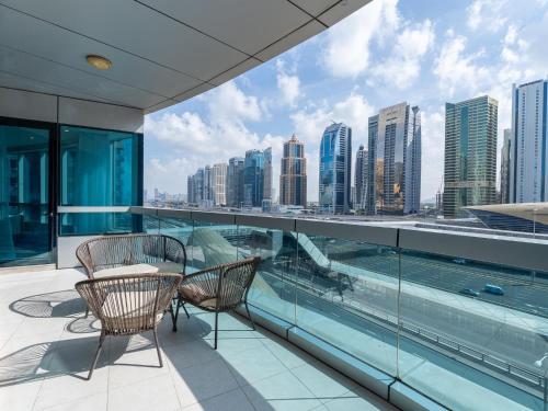 a balcony with two chairs and a view of the city at Dubai Marina Stunning Huge 4 Bedroom Apts Near JBR Gym Pool Parking in Dubai