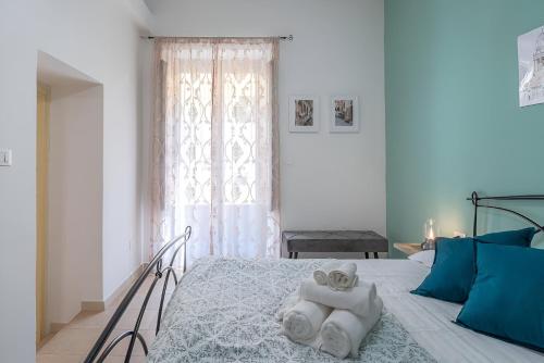 a bedroom with a bed with towels on it at Noto Barocca - HolidayHome in Noto