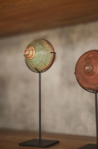 a vase on a metal stand with two other objects at Danu Villas Bali in Kerobokan