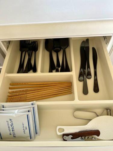 a drawer full of utensils in a refrigerator at Peaceful Lakeview Cottage 20min to Rusutsu Ski in Lake Toya