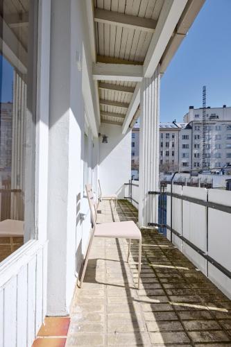 a balcony with white benches on a building at Töölö Towers in Helsinki