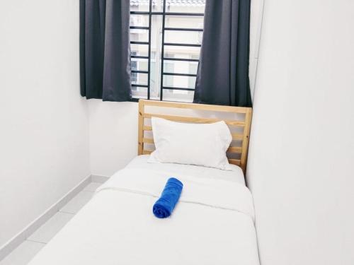 a bed in a room with a blue object on it at Area Indahpura or Taman Bersatu Kulai 3-4BR near AEON Airport JPO in Kulai