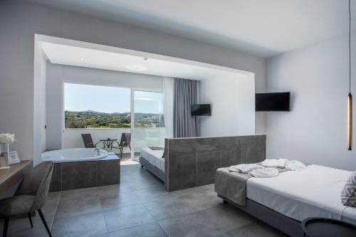 a hotel room with two beds and a bathroom at FRESH HOTEL FALIRAKI in Faliraki