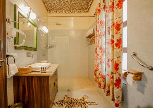 a bathroom with a leopard star on the floor at Moustache Ranthambore Luxuria in Sawāi Mādhopur