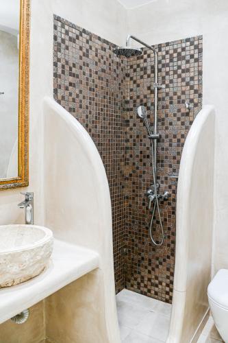 a bathroom with a shower and a sink at Georgia Pelekanou Studios in Fira