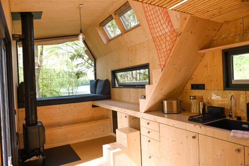 an interior view of a tiny house with a kitchen at Tiny House Pioneer 2 - Salemer See in Salem