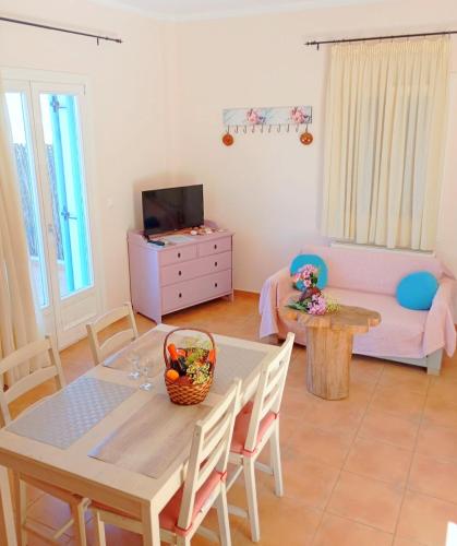 a living room with a table and a couch at Odysseion Apartments in Vathi, Ithaka