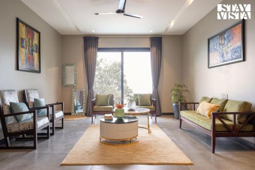 a living room with a couch and a table at StayVista at Barkat Villa with Jacuzzi in Rāmgarh