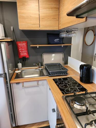 a small kitchen with a sink and a stove at Litteau 105 in Litteau