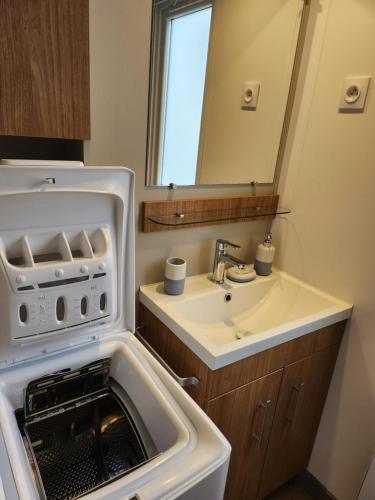 a bathroom with a sink and a microwave at Litteau 105 in Litteau