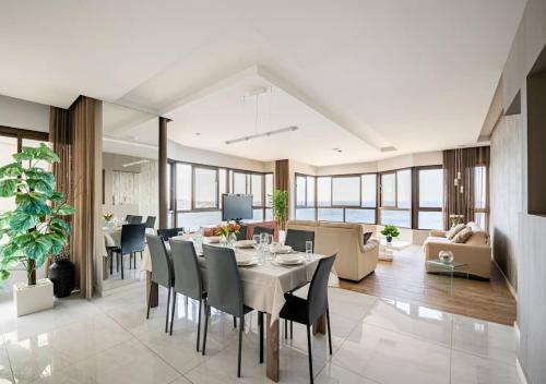 a dining room and living room with a table and chairs at Seaview Luxury Haven Living & 3Bedrooms Seafront in Sliema