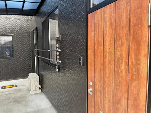 a door in a room with a toilet in it at 一棟貸しnuevoL8～丁度良い田舎、沼田で暮らすように泊まろう in Numata