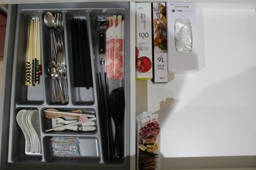 a refrigerator drawer filled with utensils and other items at 一棟貸しnuevoL8～丁度良い田舎、沼田で暮らすように泊まろう in Numata