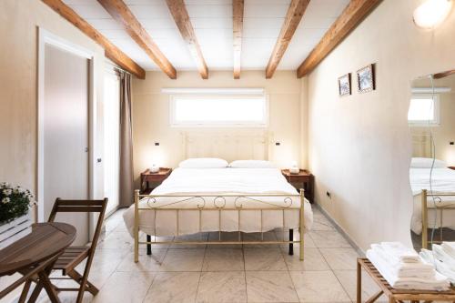 a bedroom with a bed and two tables and a window at B&B Residenza Marina in Marina di Carrara