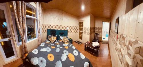 a bedroom with a large bed in a room at D’SHIEKHS RESORT GUREZ in Kanzalwan