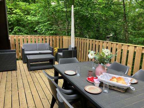 a black table with a tray of food on a deck at Chalet Tournesol Durbuy in Durbuy
