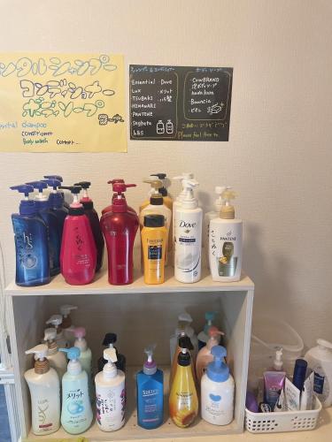 a shelf filled with lots of different colored bottles at Karuizawa Pension Sato no Nukumori in Karuizawa