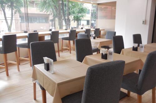 a row of tables and chairs in a room at Hotel Ohedo in Tokyo