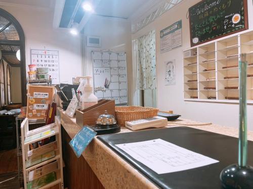 a shop counter with a chalkboard on the wall at Karuizawa Pension Sato no Nukumori in Karuizawa