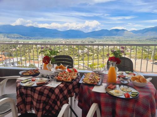 una mesa con platos de comida en la parte superior de un balcón en Vila Marjana, en Sarandë