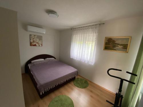 Vila Dolce Vita Mostar في موستار: غرفة نوم صغيرة بها سرير ونافذة