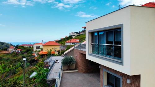 a view of a building from a balcony at Capela's House in Ribeira Brava