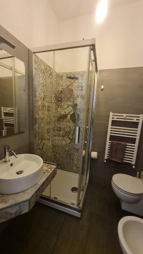a bathroom with a shower and a sink and a toilet at B&B Verdeoliva in Modugno