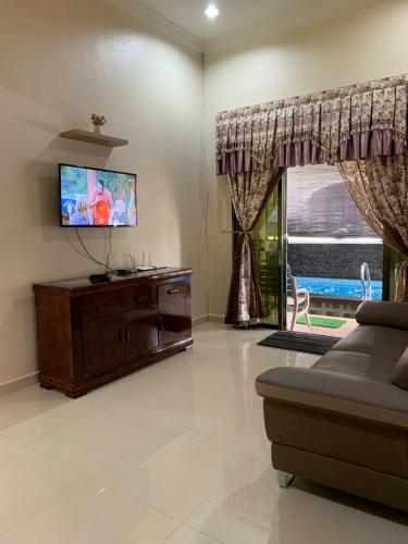 TV a/nebo společenská místnost v ubytování Mayyah Guest House