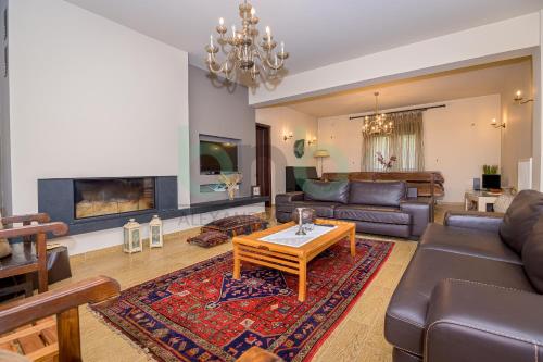 a living room with a couch and a table at ''Villa Elia'' in Dhíkella