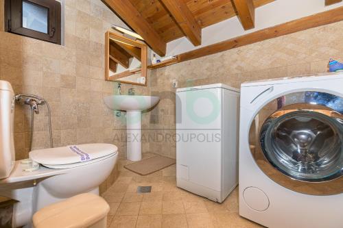 a bathroom with a washing machine and a toilet at ''Villa Elia'' in Dhíkella