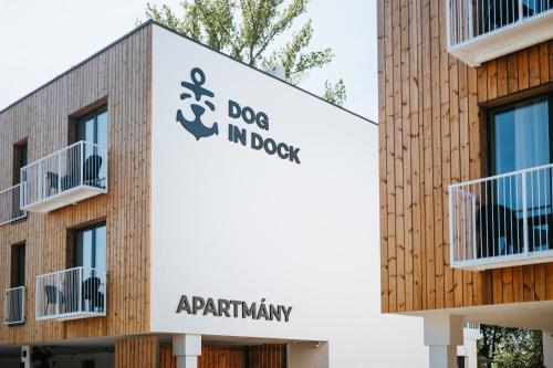 a building with a dog in the dog in the box sign at Apartmány Dog in Dock in Veselí nad Moravou