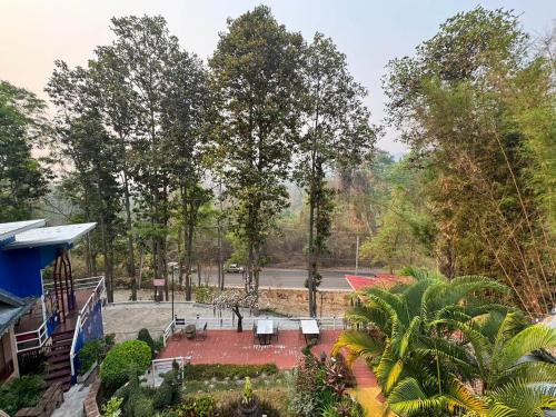 an aerial view of a garden with trees in the background at Phu Jaya Floresta Resort by ALPHATEL PARTNER in Chiang Mai