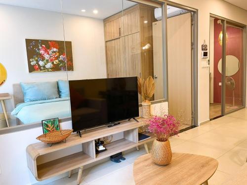 a living room with a large flat screen tv at The Sóng Vũng Tàu - Mochi House in Vung Tau