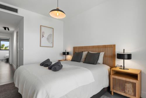 ein Schlafzimmer mit einem großen weißen Bett und zwei Lampen in der Unterkunft Luxury Seaview Resort Apartment in Manilva