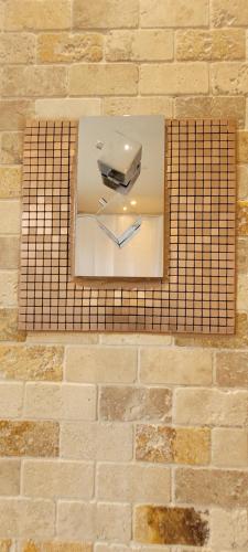 a brick wall with a window with a clock on it at Loughton 3 Bedroom Sleeps 5 by BSE Homes in Loughton