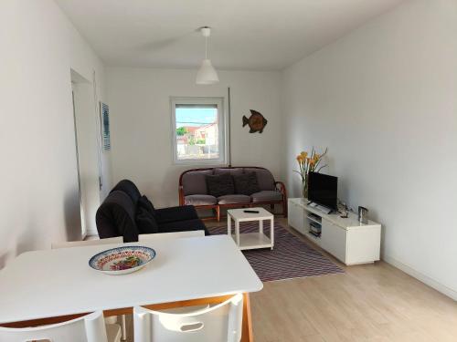 a living room with a couch and a table at Casa da Ilha dos Ovos in Aveiro