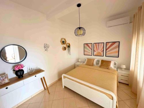 sypialnia z łóżkiem i lustrem w obiekcie Kalderimi View House w mieście Dhërmi