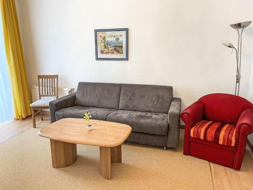 a living room with a couch and a coffee table at Apartment Villa Imperator by Interhome in Ostseebad Sellin