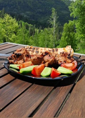 a plate of food on top of a wooden table at Obriyslavsko in Slavske