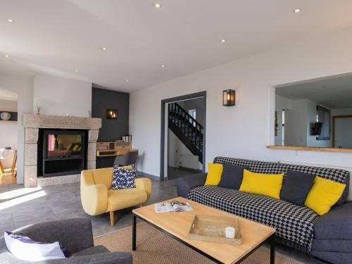 a living room with a couch and a table at Holiday Home La Vigie - LPU104 by Interhome in Clohars-Carnoët
