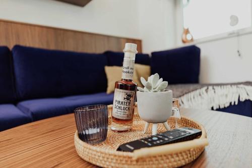 una botella de whisky y un mando a distancia en una mesa en Fewo Haubentaucher Haus Wangerooge, en Hooksiel