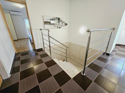 a room with a staircase with a checkerboard floor at Čarobni pogled Zagreb in Zagreb