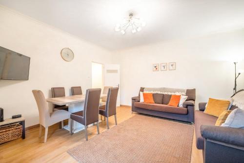 a living room with a table and a couch at GuestReady - Spacious Apt near Cascais City Centre in Alvide