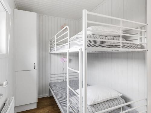 two white bunk beds in a white room at Chalet Sandsjöfors by Interhome in Sandsjöfors