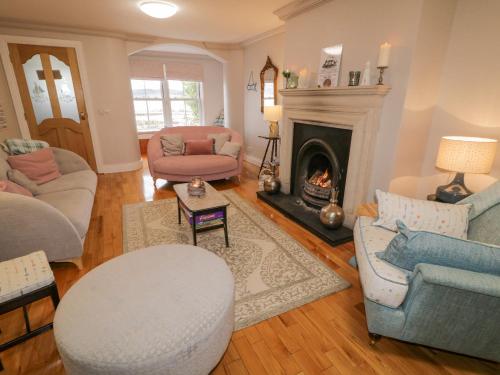 a living room filled with furniture and a fireplace at 3 Coastguard Station in Rathmullan