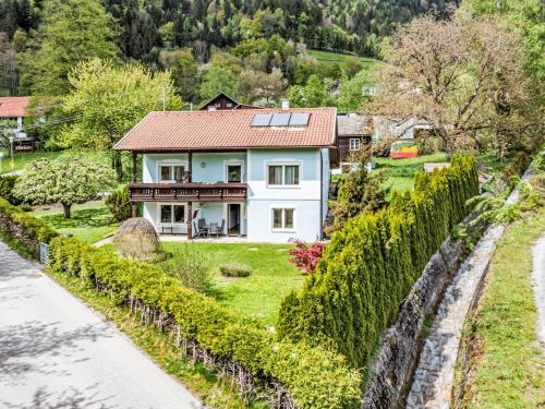 a white house with a red roof at Apartment Schneeberger by Interhome in Tratten