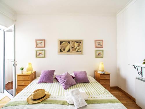 a bedroom with a bed with a hat on it at Apartment Navegante by Interhome in Monte Gordo