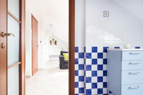 a bathroom with a blue and white checkered floor at A Pochi Passi in Venaria Reale